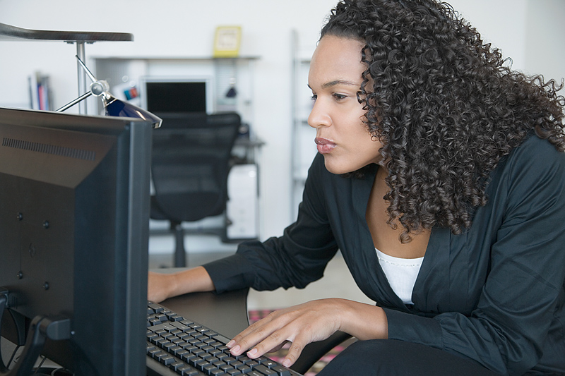 Bilden föreställer kvinna framför datorskärm